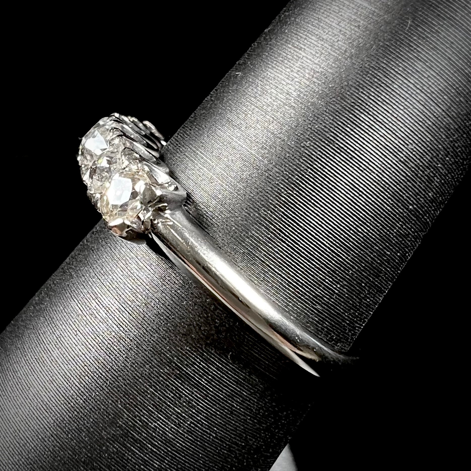 An antique white gold diamond wedding band set with six old mine cut natural diamonds.