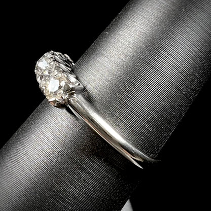 An antique white gold diamond wedding band set with six old mine cut natural diamonds.