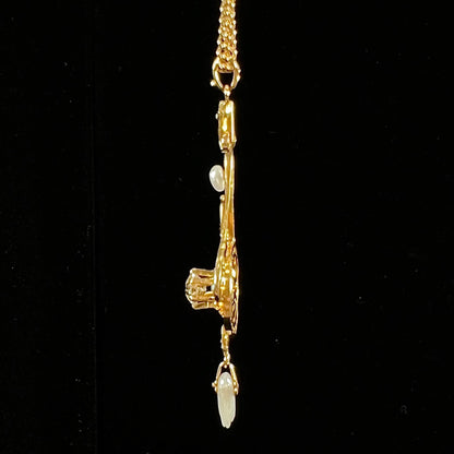 A ladies' Edwardian style gold necklace set with pearls and an old mine cut diamond.  The chain is marked "1916".