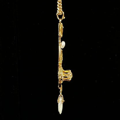 A ladies' Edwardian style gold necklace set with pearls and an old mine cut diamond.  The chain is marked "1916".