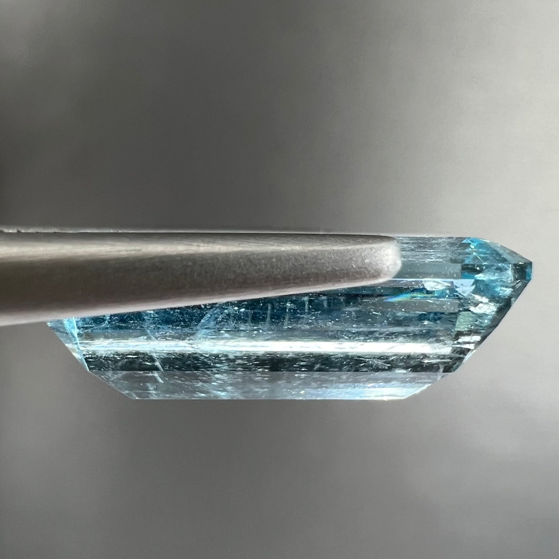 A loose, emerald cut aquamarine stone from Vietnam.  The stone is an ice blue color.