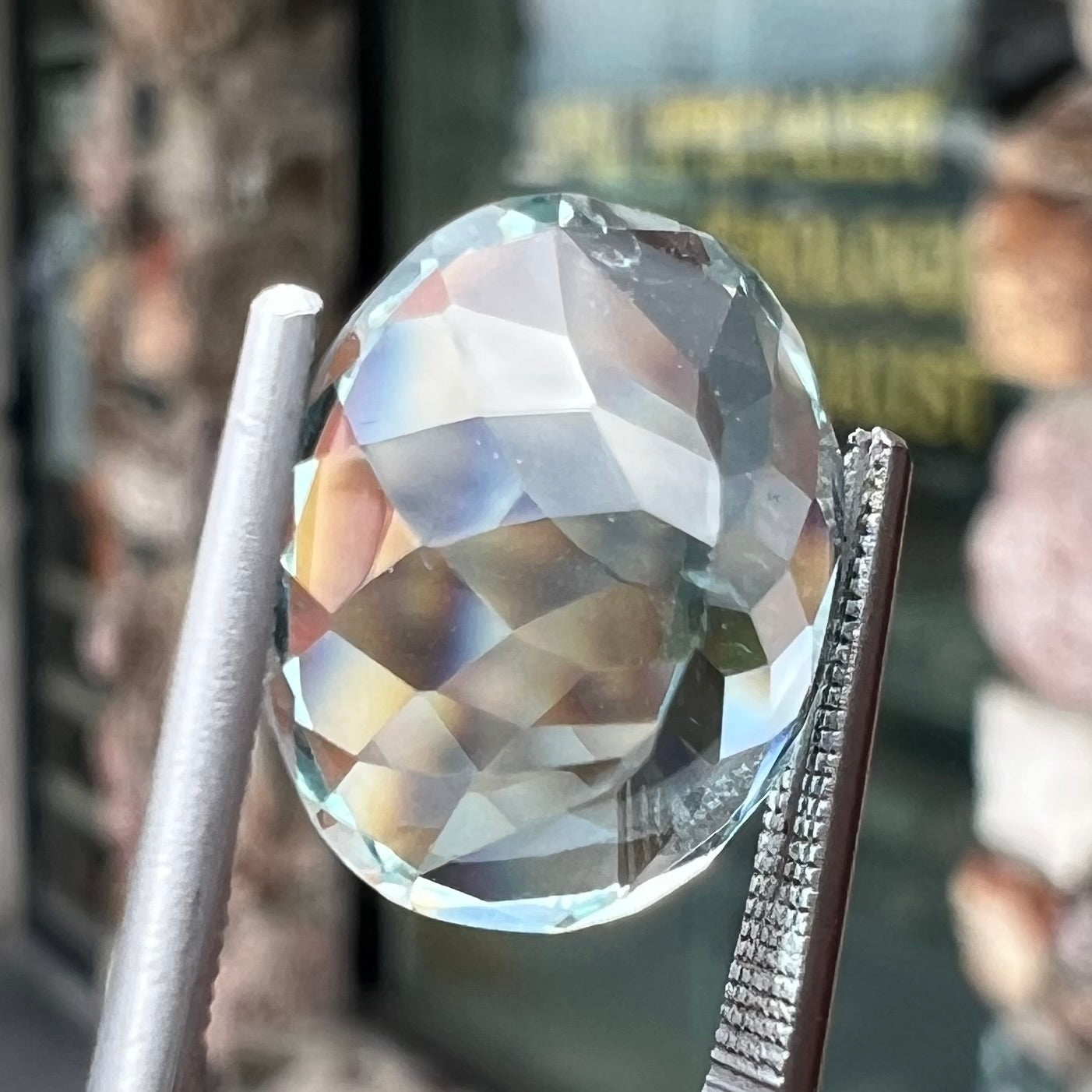 A loose, faceted oval cut aquamarine gemstone from Brazil.  The stone is greenish blue color.