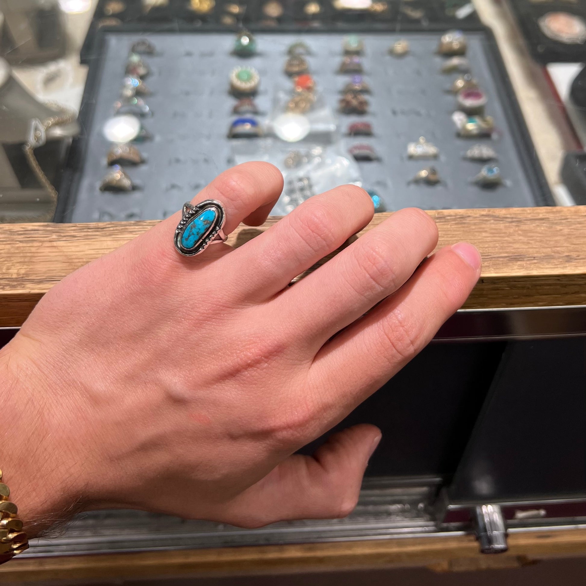 A handmade sterling silver Navajo style ring set with a Morenci turquoise stone.