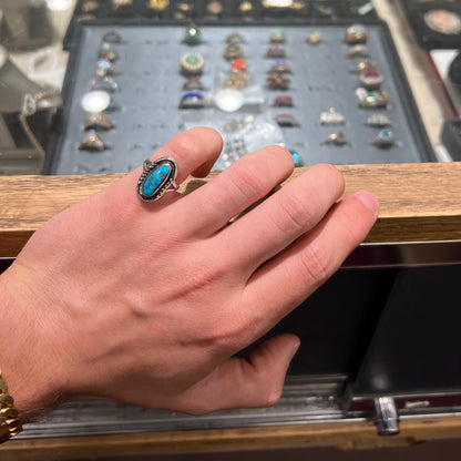 A handmade sterling silver Navajo style ring set with a Morenci turquoise stone.