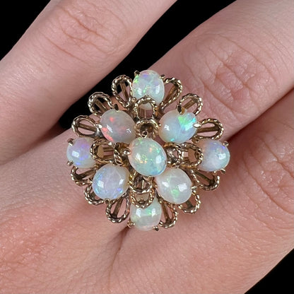 A ladies' yellow gold opal cluster ring.  The ring is an atomic motif, handmade in the mid-century modern style.