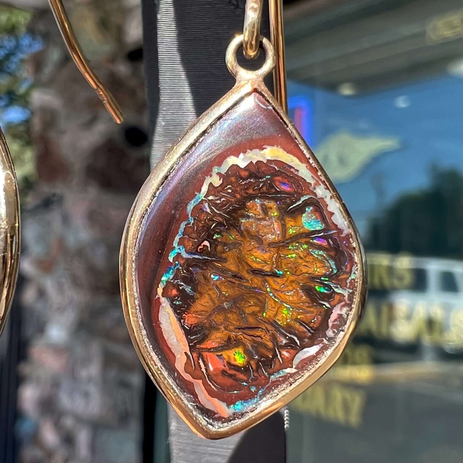 A pair of yellow gold dangle earrings bezel set with natural boulder opals from Koroit, Australia.