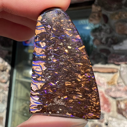 A loose boulder opal stone from Koroit, Australia.  The opal has a blue and purple pattern.