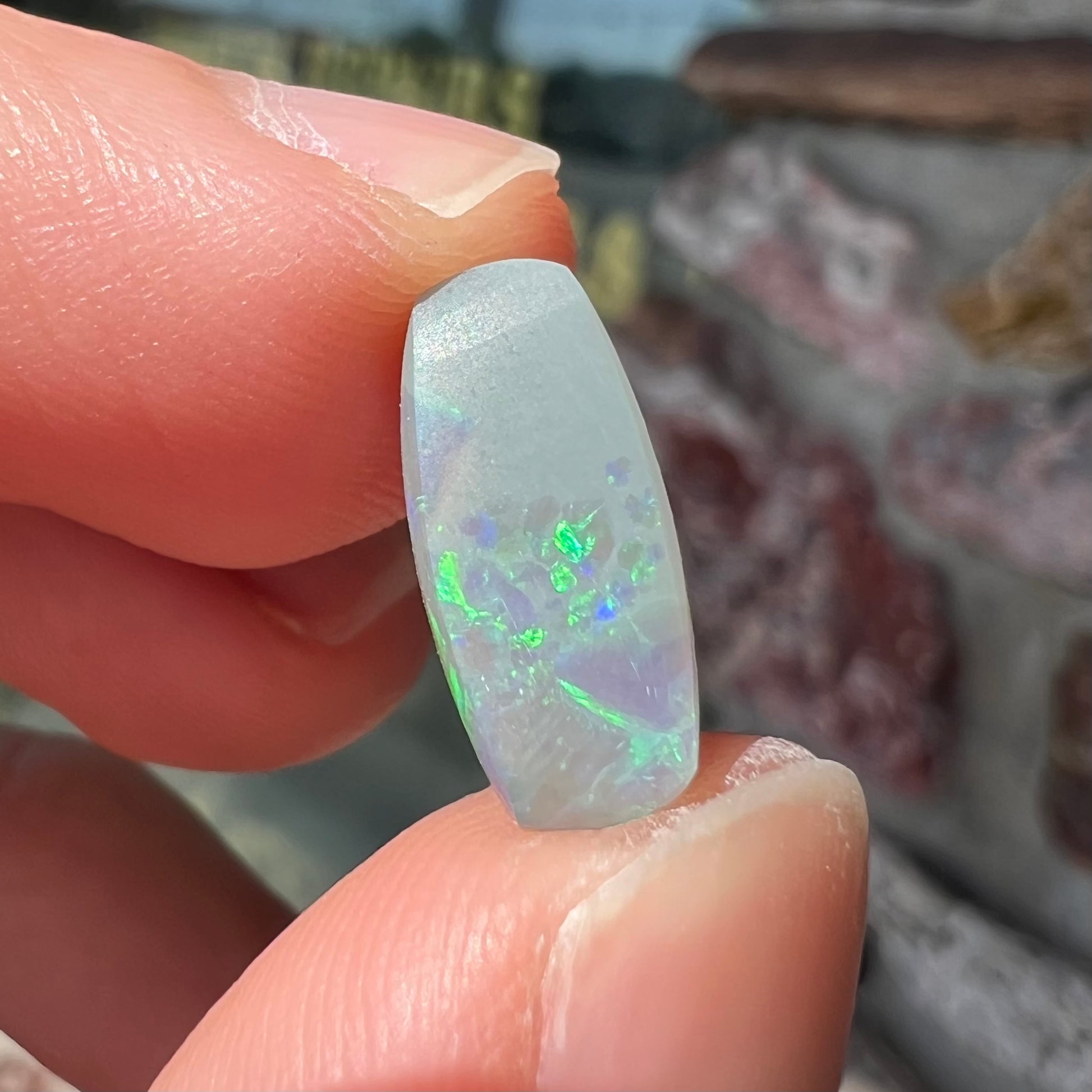 A loose, barrel shaped opal stone from Lightning Ridge, Australia.