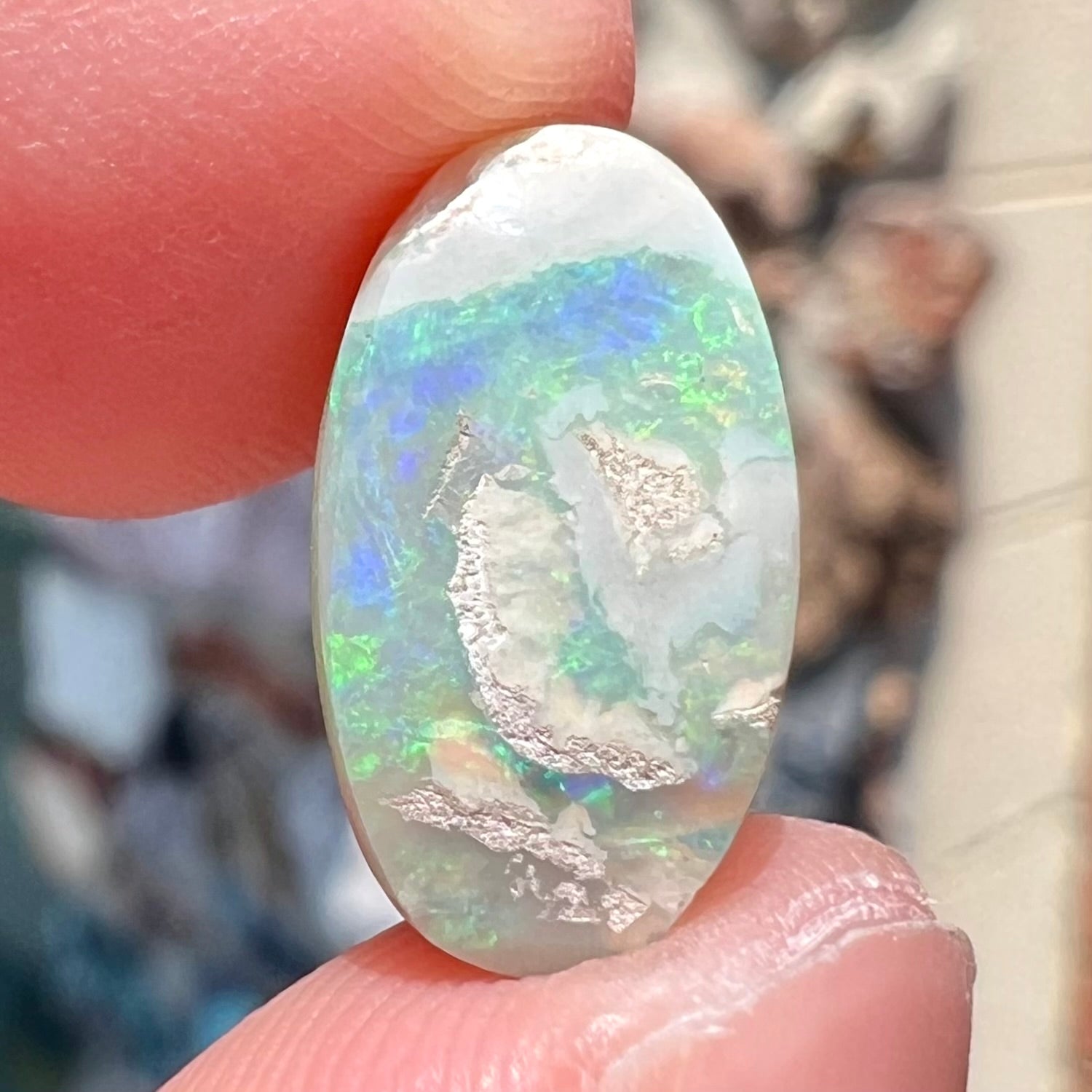 A loose, Lightning Ridge light crystal opal.  The opal is predominantly green.