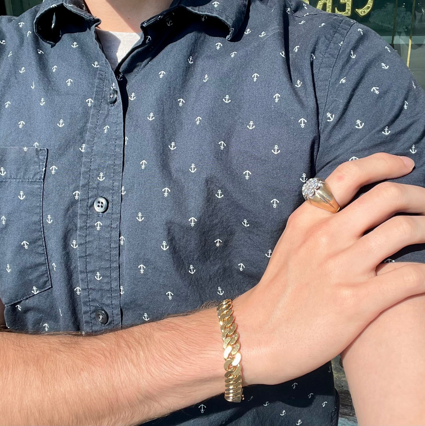 A men's textured yellow gold ring set with a cluster of seven round brilliant cut natural diamonds.