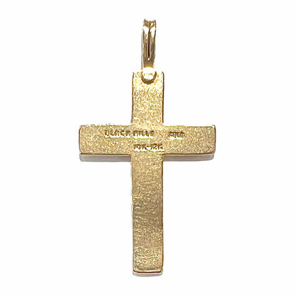 A cross made from yellow and rose gold Black Hills gold.  The cross features a leaf design.