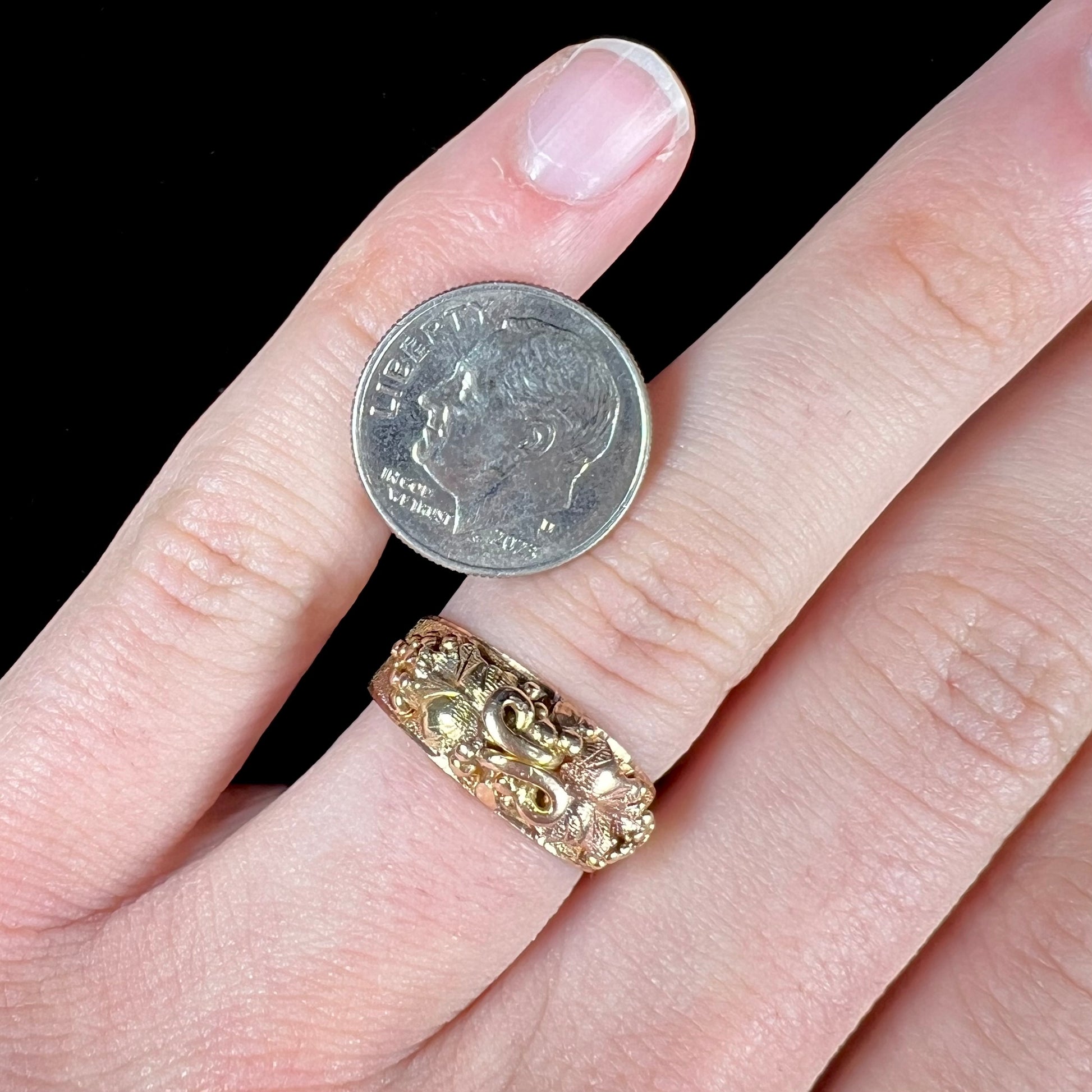 A ladies' two-tone Black Hills gold ring featuring the motif of leaves.  The inside of the ring is stamped "16K" and "BARCLAY".
