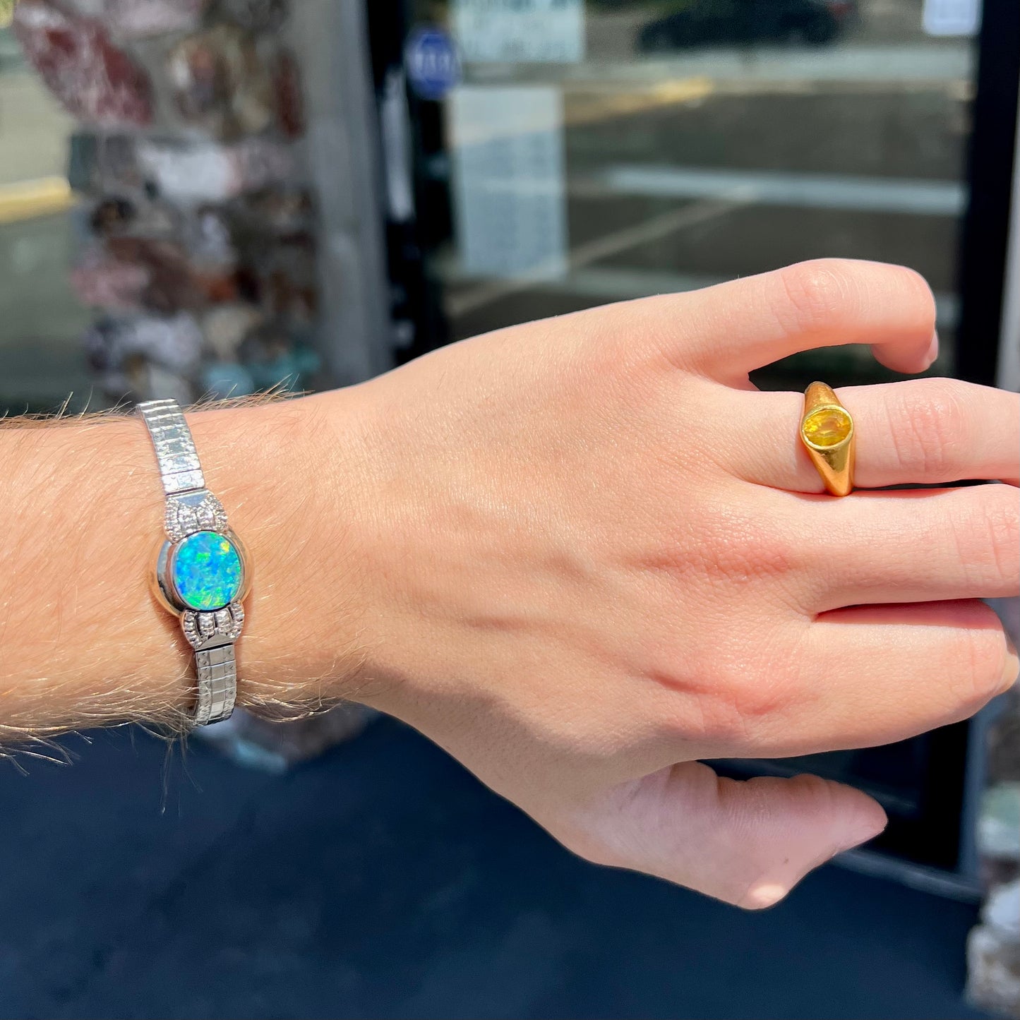 A ladies' art deco style white gold and stainless steel bracelet set with a natural black opal doublet and diamonds.