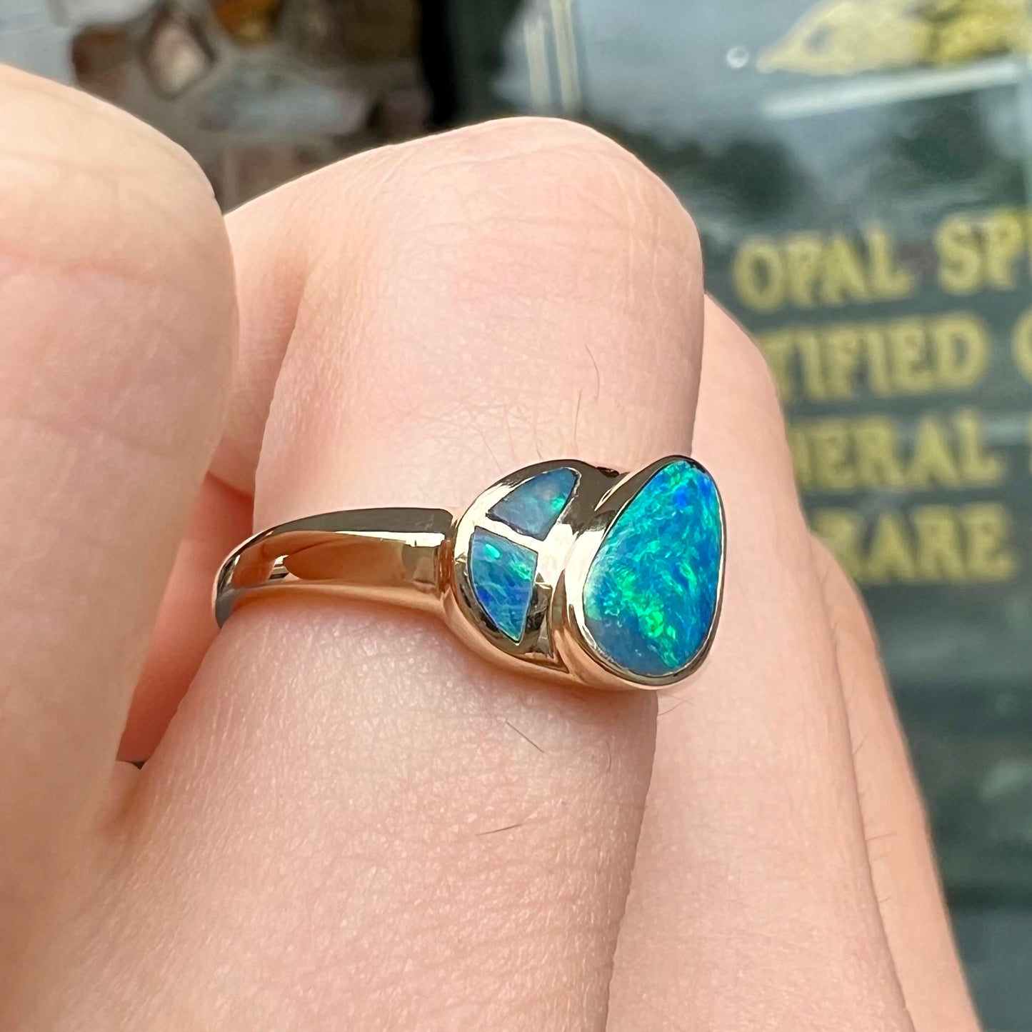 A ladies' black opal inlay ring cast in yellow gold.