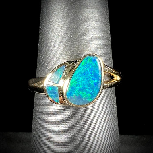 A ladies' black opal inlay ring cast in yellow gold.