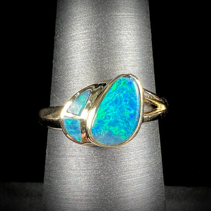 A ladies' black opal inlay ring cast in yellow gold.