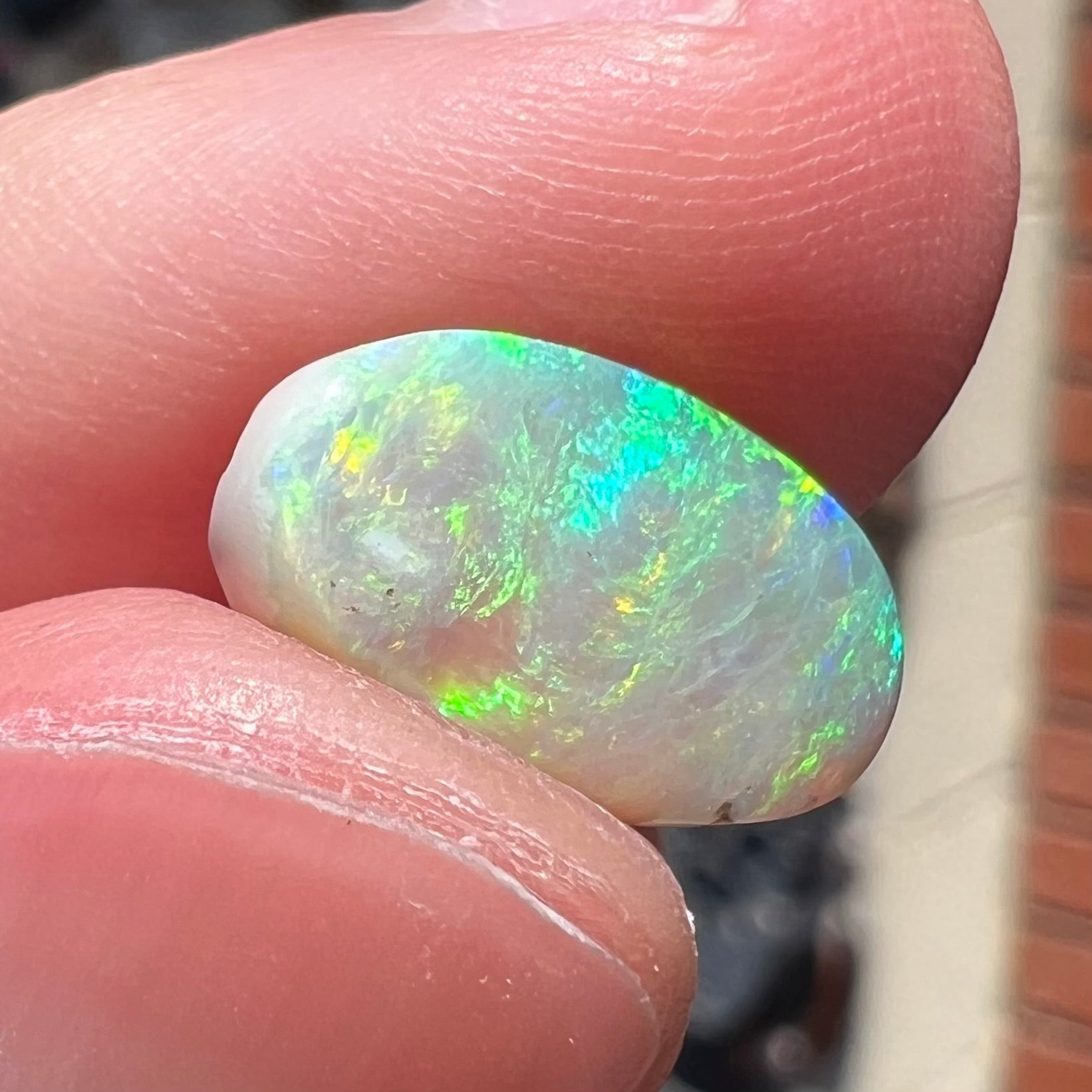 A loose, Lightning Ridge light crystal opal.  The opal is predominantly green.