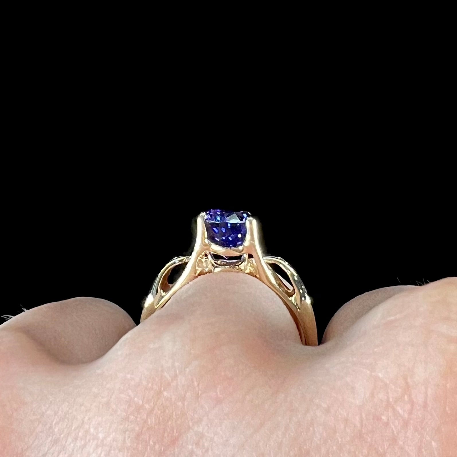 A ladies' oval cut tanzanite solitaire ring set in yellow gold.