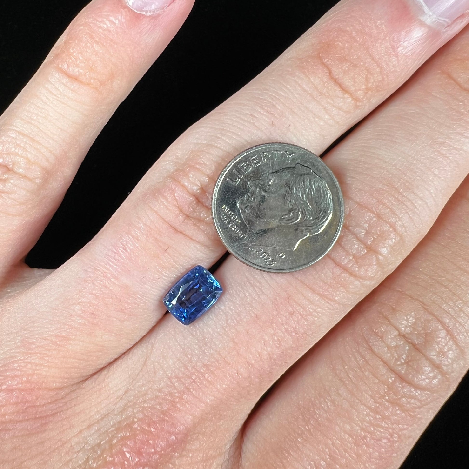 A loose, blue kyanite gemstone.  The stone is a faceted cushion cut.