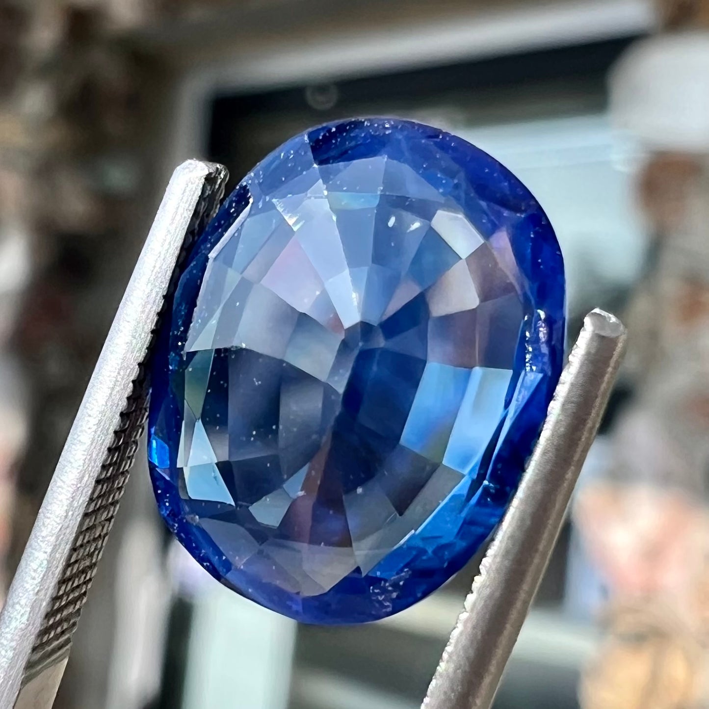 A 4.80 carat oval cut blue sapphire stone.  The stone is natural and has been heated to enhance its blue color.