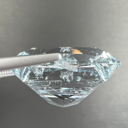 A loose, faceted French cut Russian topaz gemstone.  The stone is a light blue color.