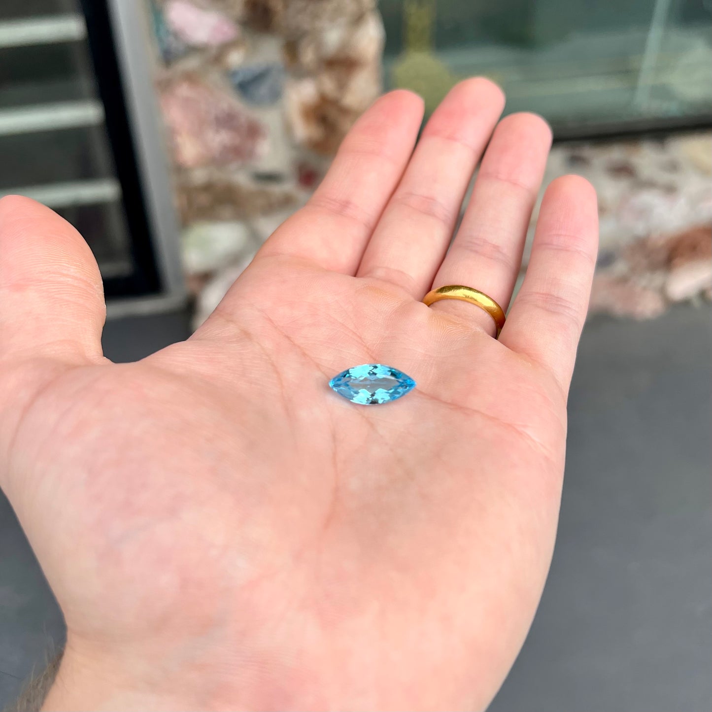 A loose, marquise cut blue topaz gemstone.