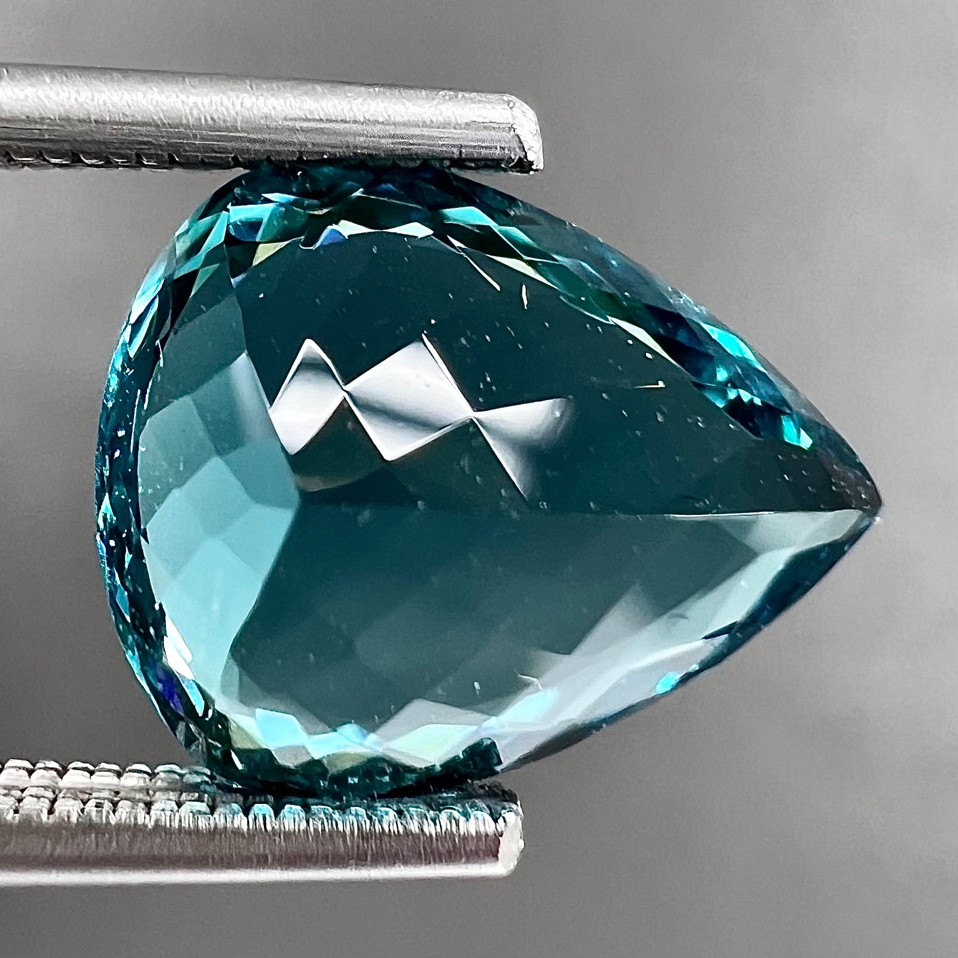 A loose, pear shaped green-blue indicolite tourmaline stone.