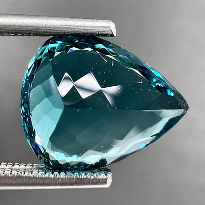 A loose, pear shaped green-blue indicolite tourmaline stone.