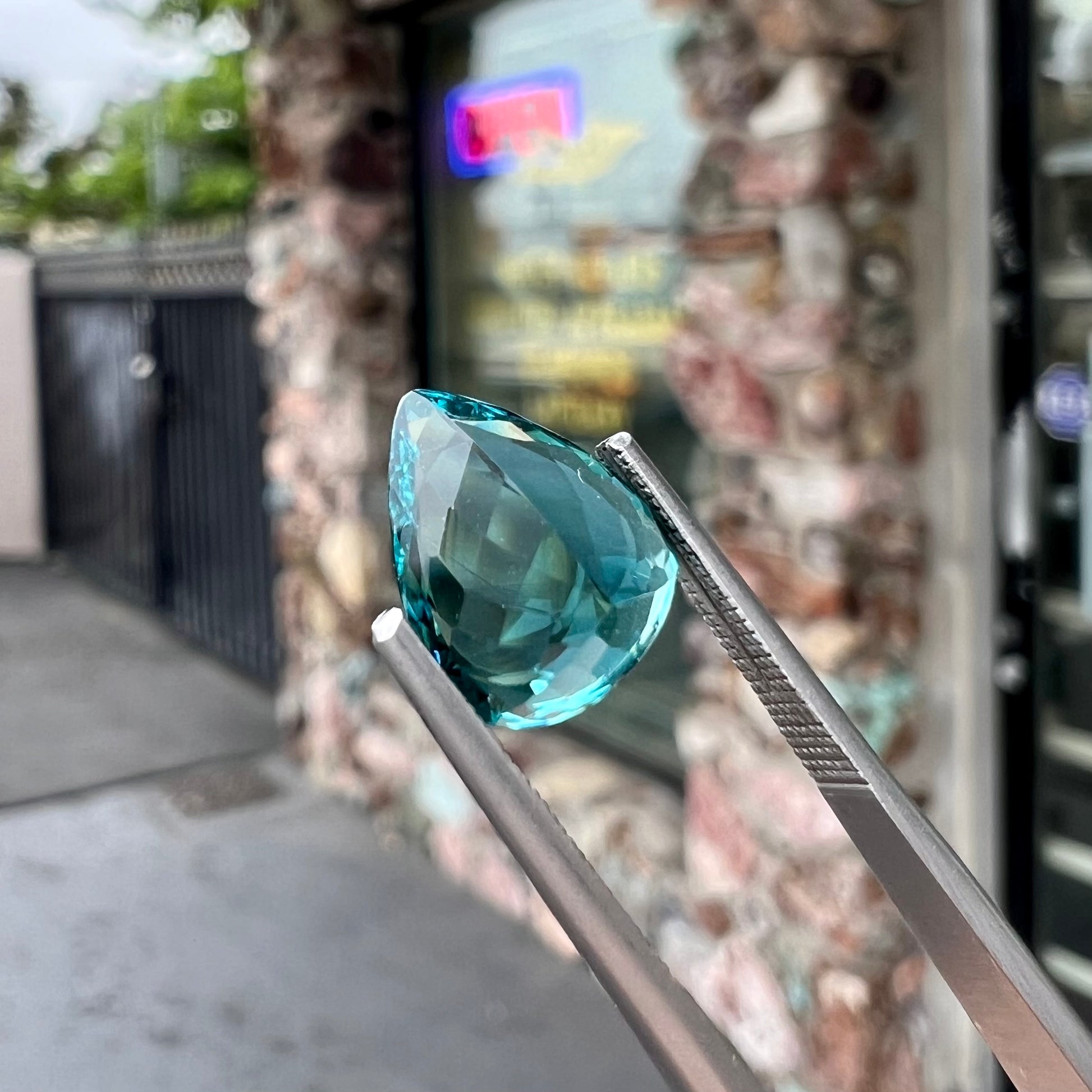 A loose, pear shaped green-blue indicolite tourmaline stone.