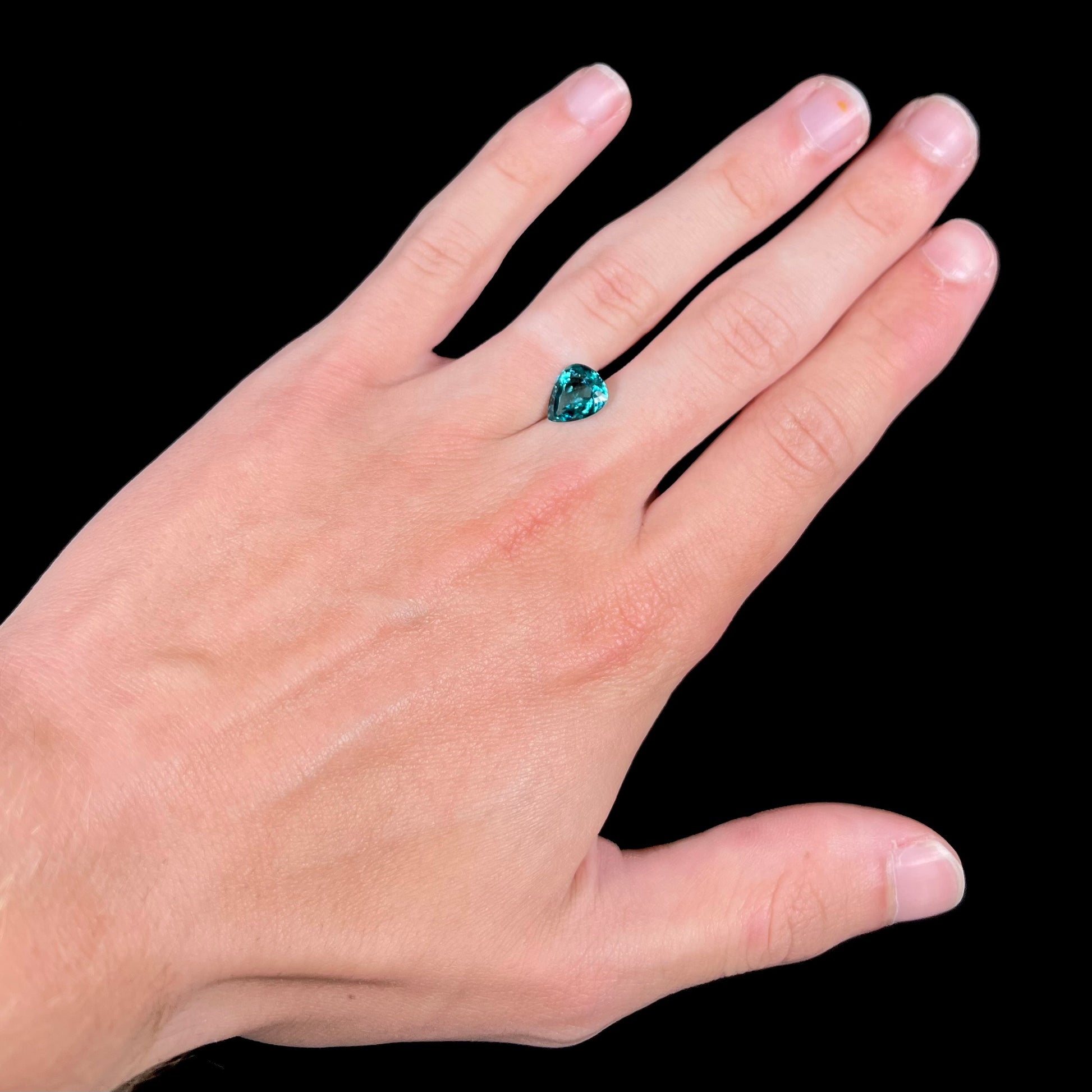 A loose, pear shaped green-blue indicolite tourmaline stone.