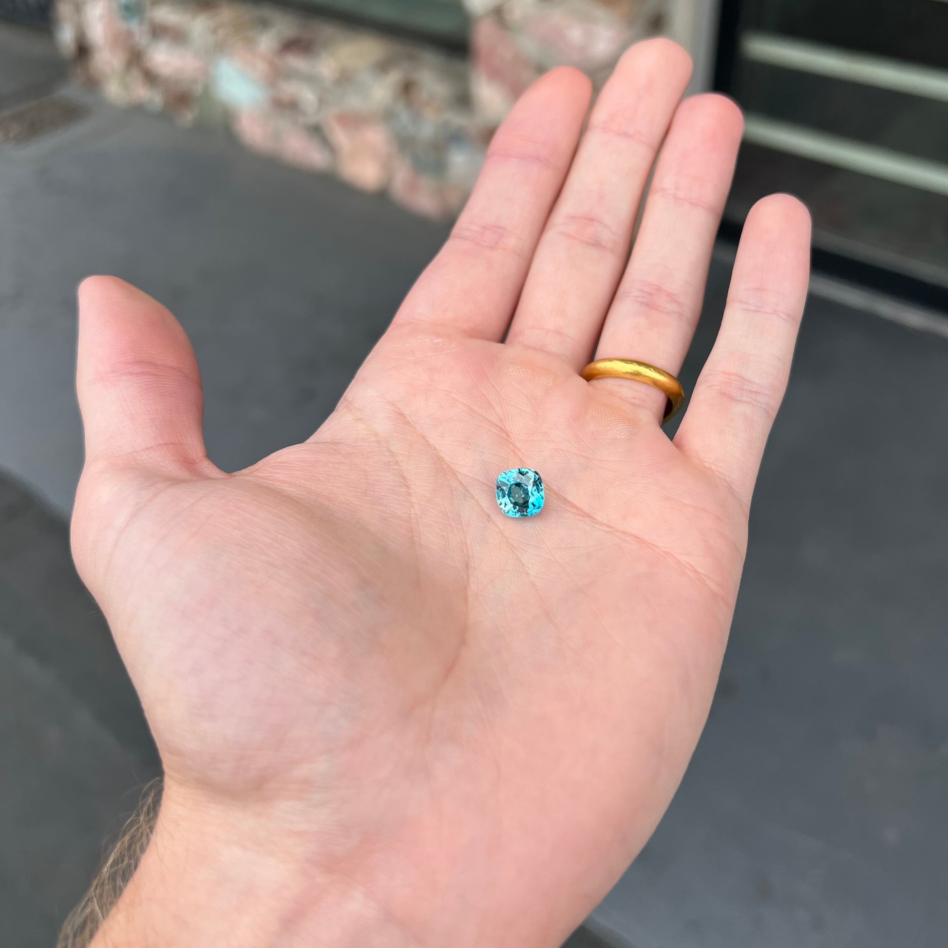 A loose cushion cut blue zircon stone.