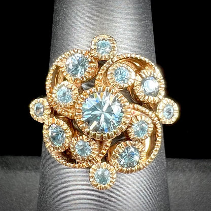 A ladies' yellow gold estate cluster ring set with natural blue zircon stones.