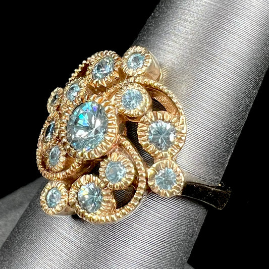 A ladies' yellow gold estate cluster ring set with natural blue zircon stones.