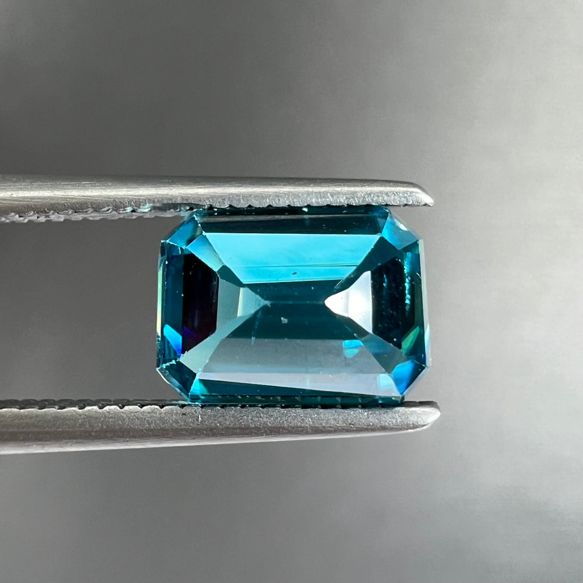 A natural blue zircon gemstone.  The stone is emerald cut.