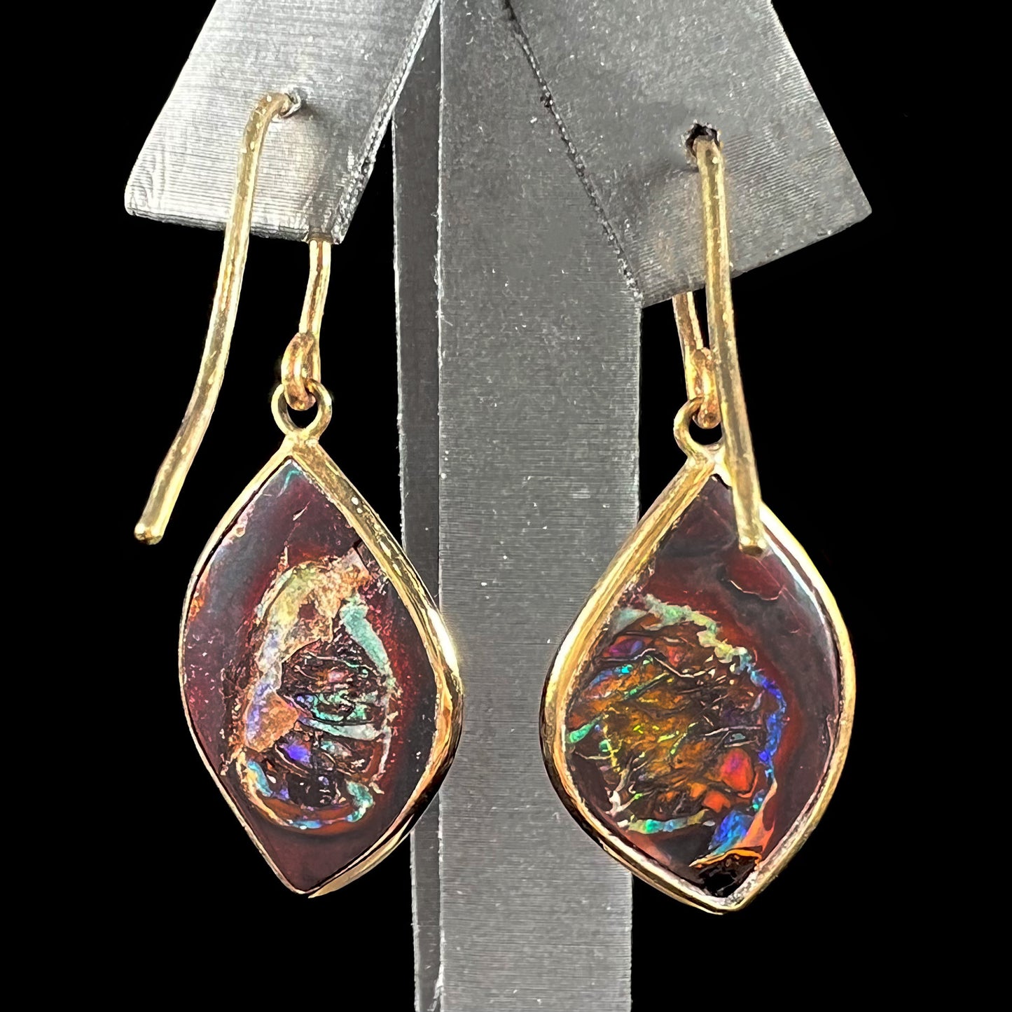 A pair of yellow gold dangle earrings bezel set with natural boulder opals from Koroit, Australia.