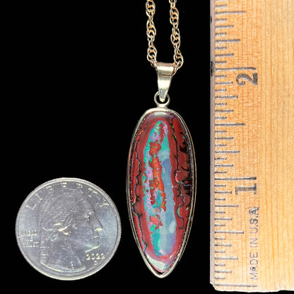 A yellow gold pendant set with a natural Yowah nut boulder opal stone.