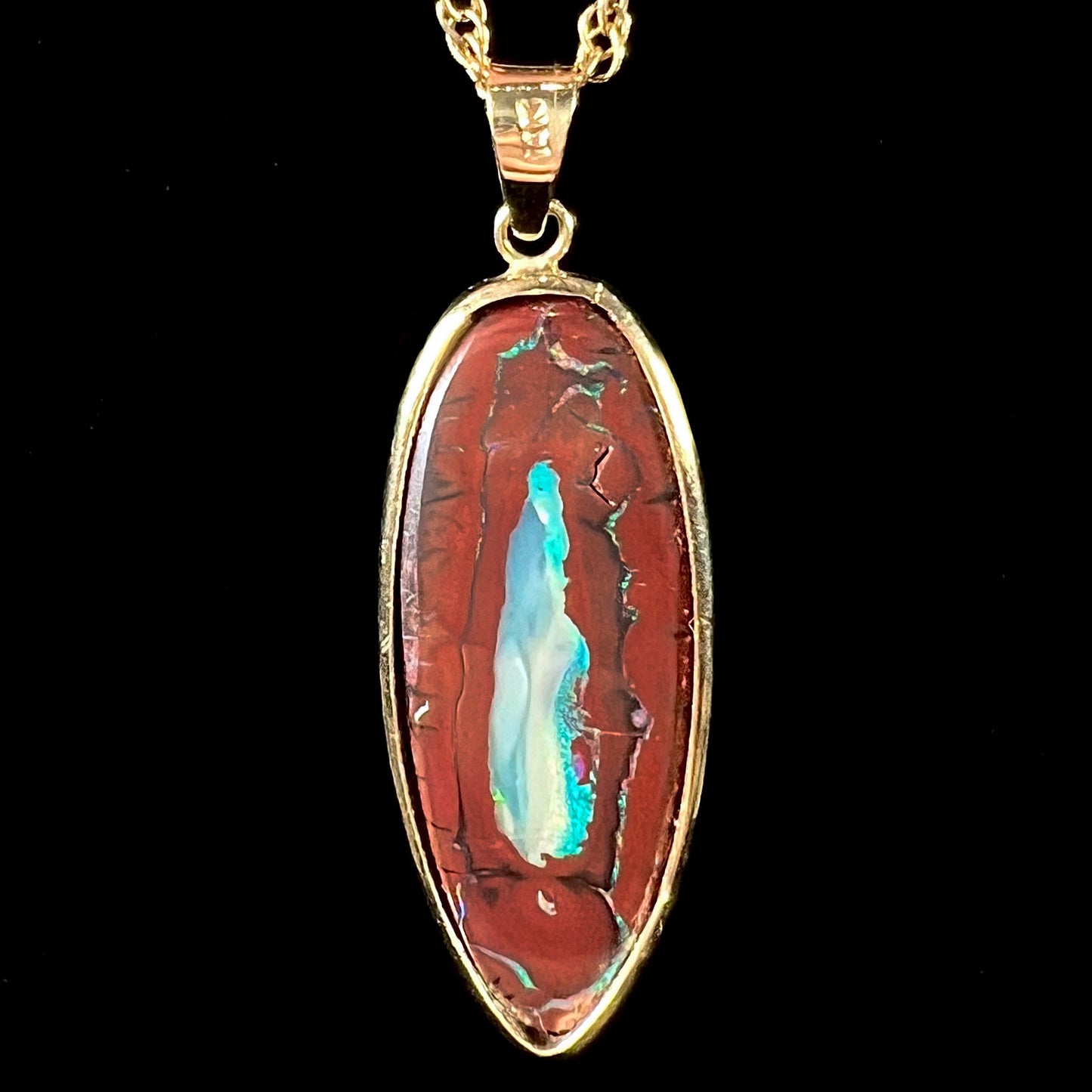 A yellow gold pendant set with a natural Yowah nut boulder opal stone.