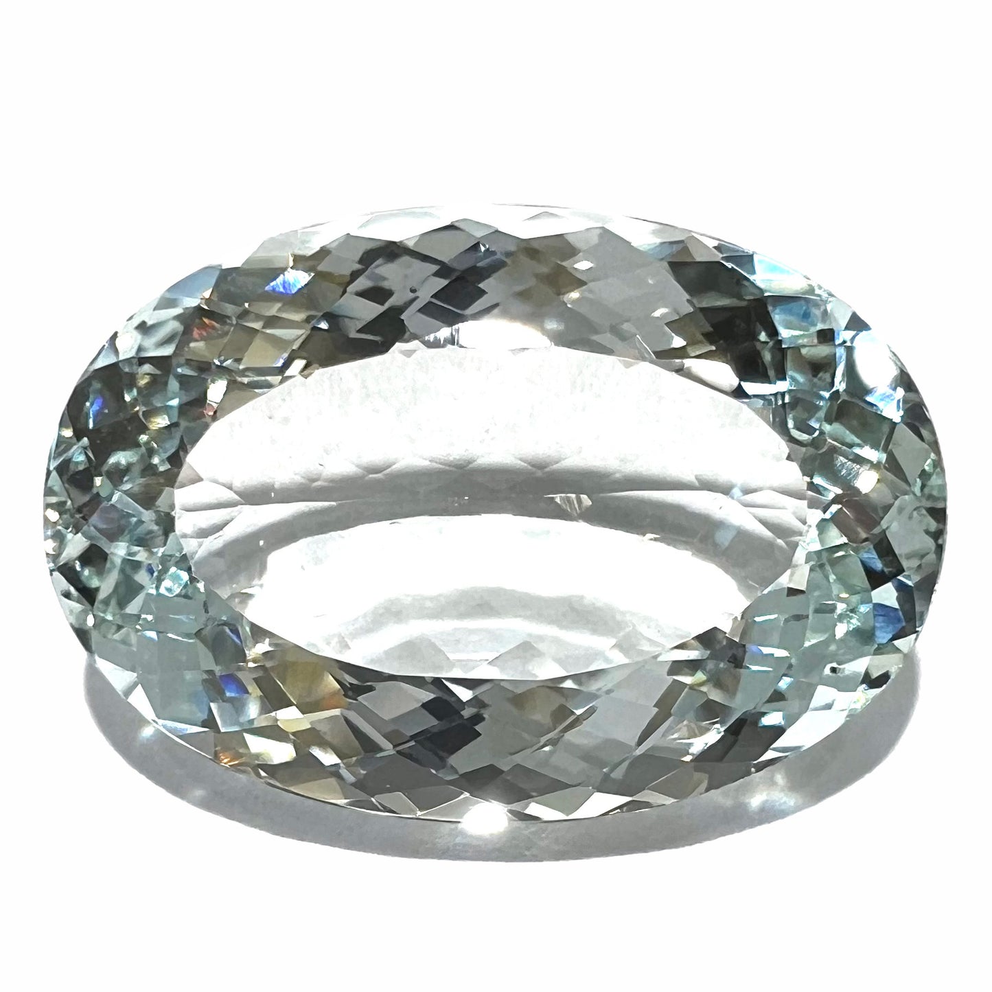 A faceted oval cut Brazilian aquamarine gemstone.  The stone is a light blue color.