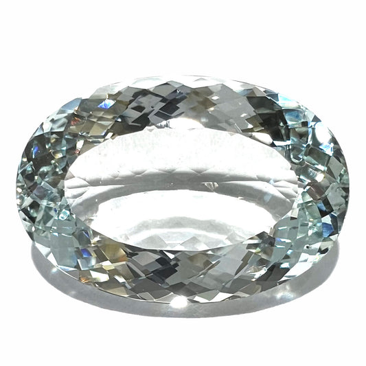 A faceted oval cut Brazilian aquamarine gemstone.  The stone is a light blue color.