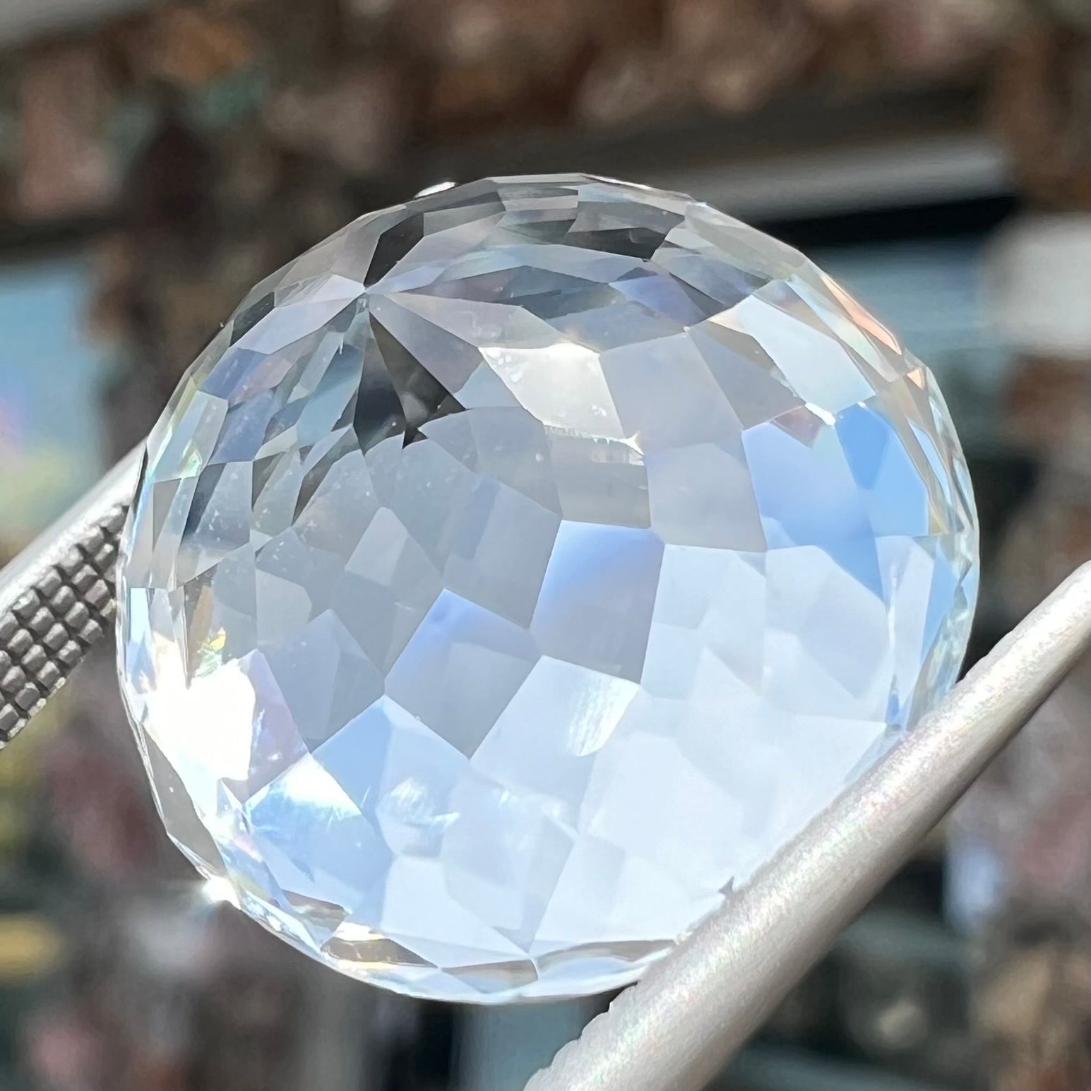 A large, round brilliant cut white topaz gemstone.