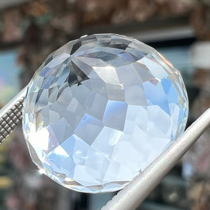 A large, round brilliant cut white topaz gemstone.