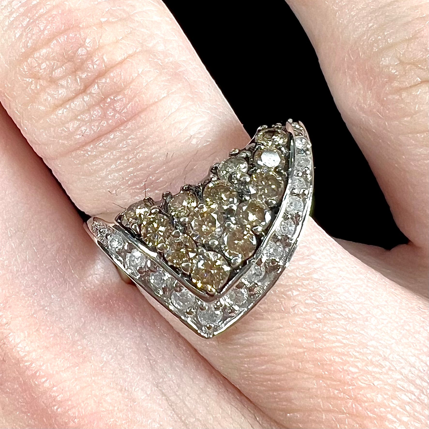 A ladies' white gold ring set with clusters of brown champagne and white diamonds.
