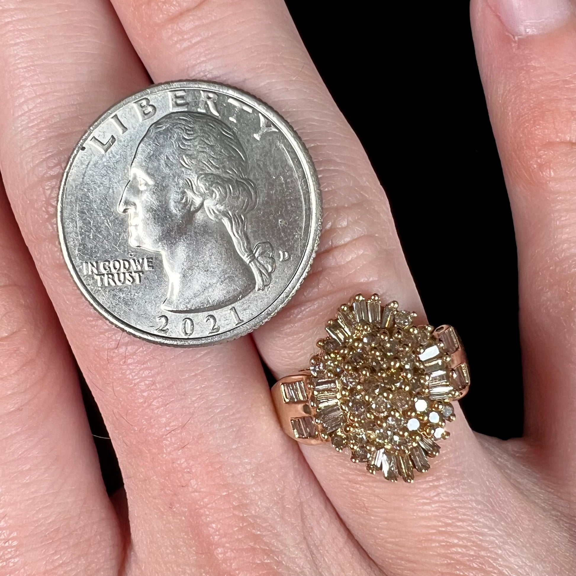 A ladies' cluster ring set with round and baguette cut cognac brown diamonds.