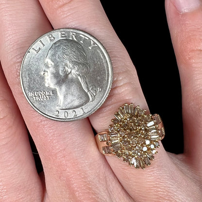 A ladies' cluster ring set with round and baguette cut cognac brown diamonds.