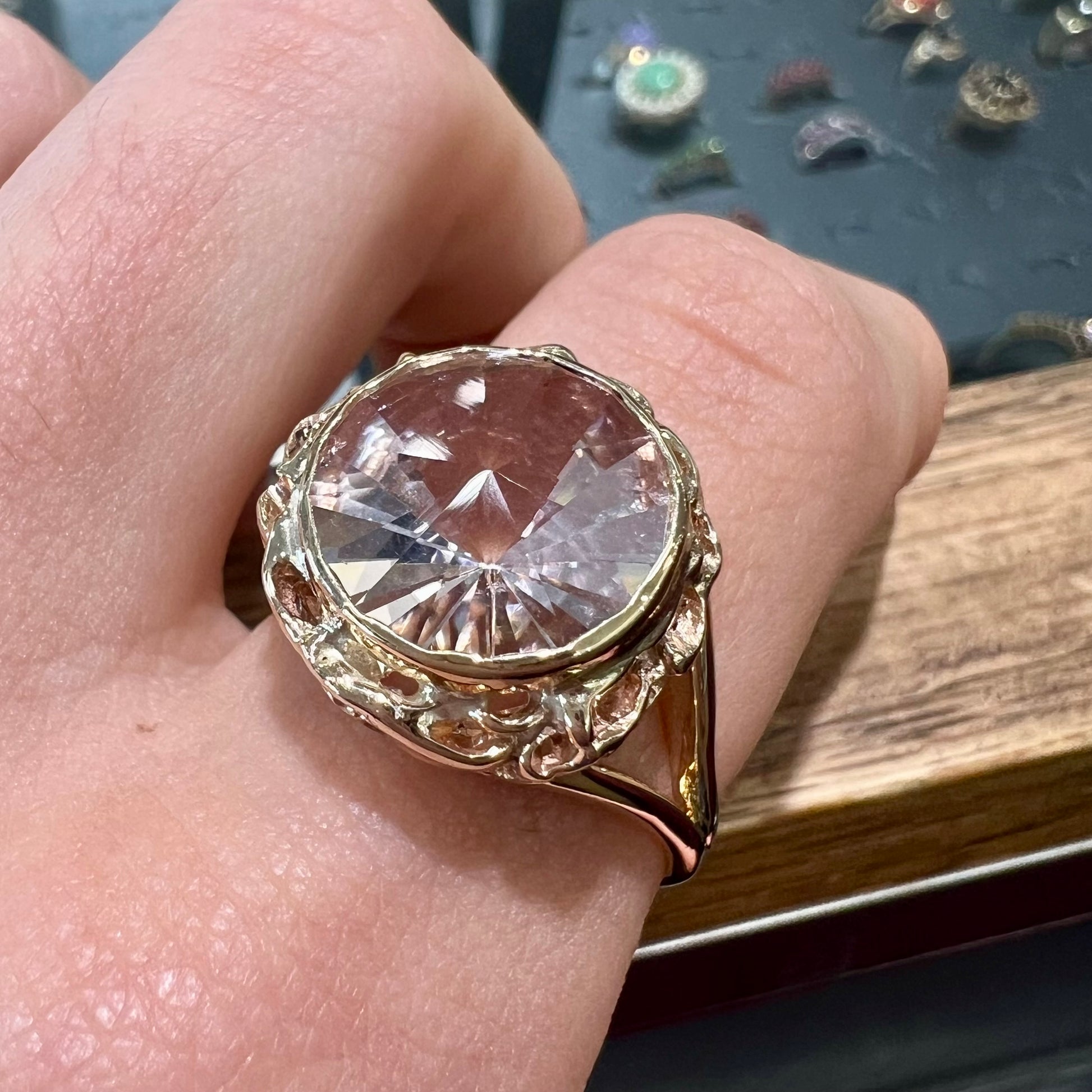 A ladies' yellow gold solitaire ring bezel set with a modified bud cut morganite gemstone.