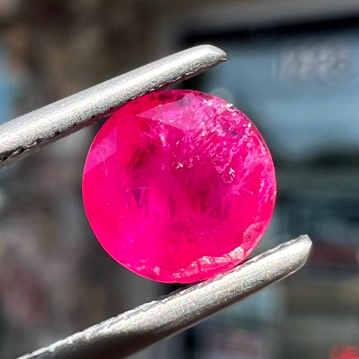 A faceted round brilliant cut Burma ruby gemstone.  The stone is certified as natural by Guild Laboratories.