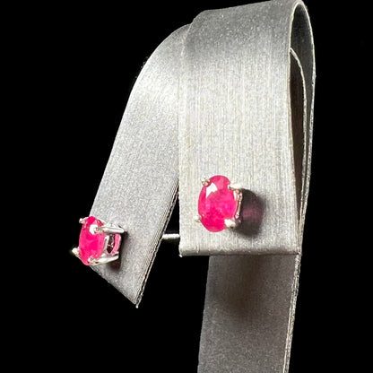 A pair of natural Burma ruby stud earrings set in white gold.  The rubies are a purplish red color.