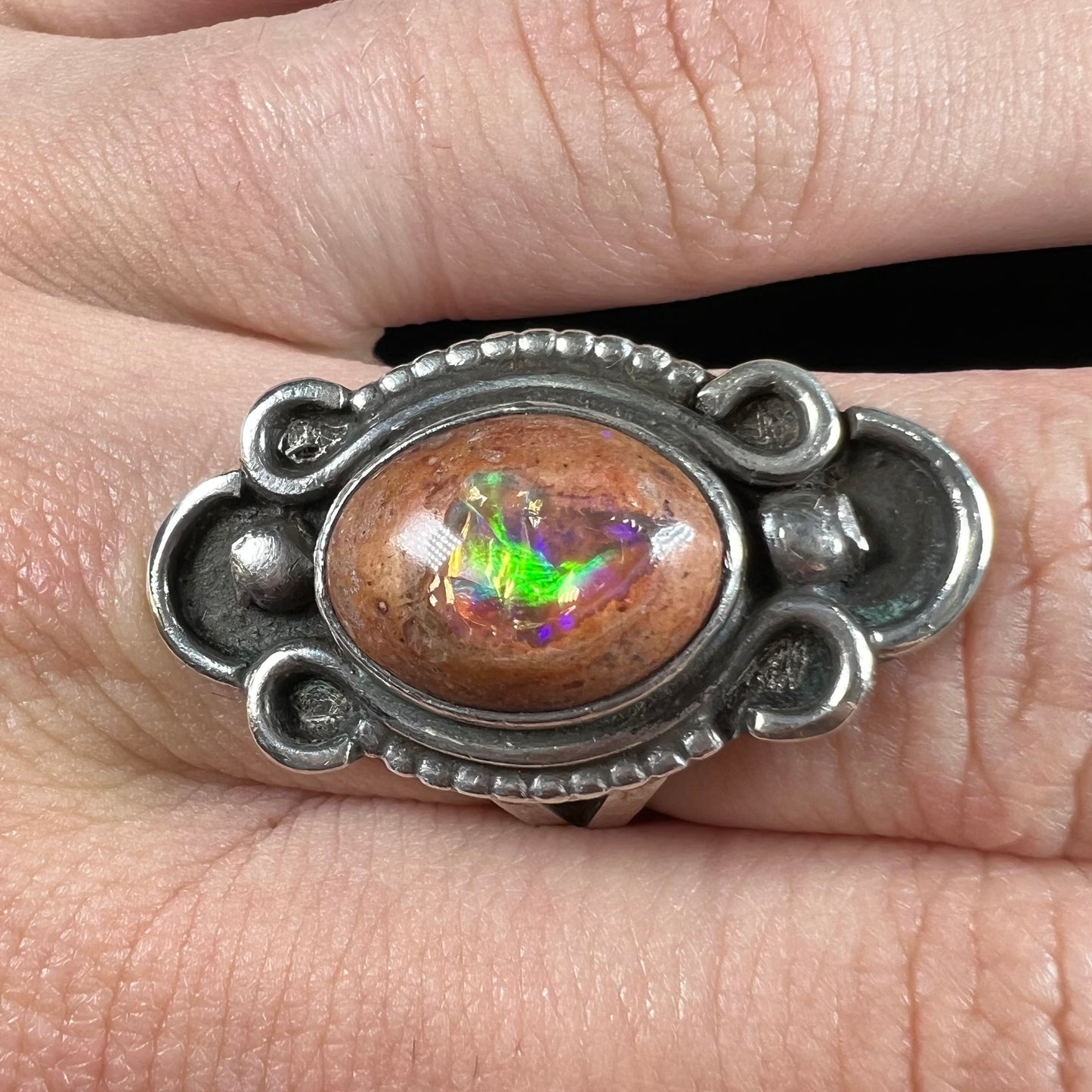 A vintage, Navajo style sterling silver ring set with an oval cabochon cut cantera fire opal stone.