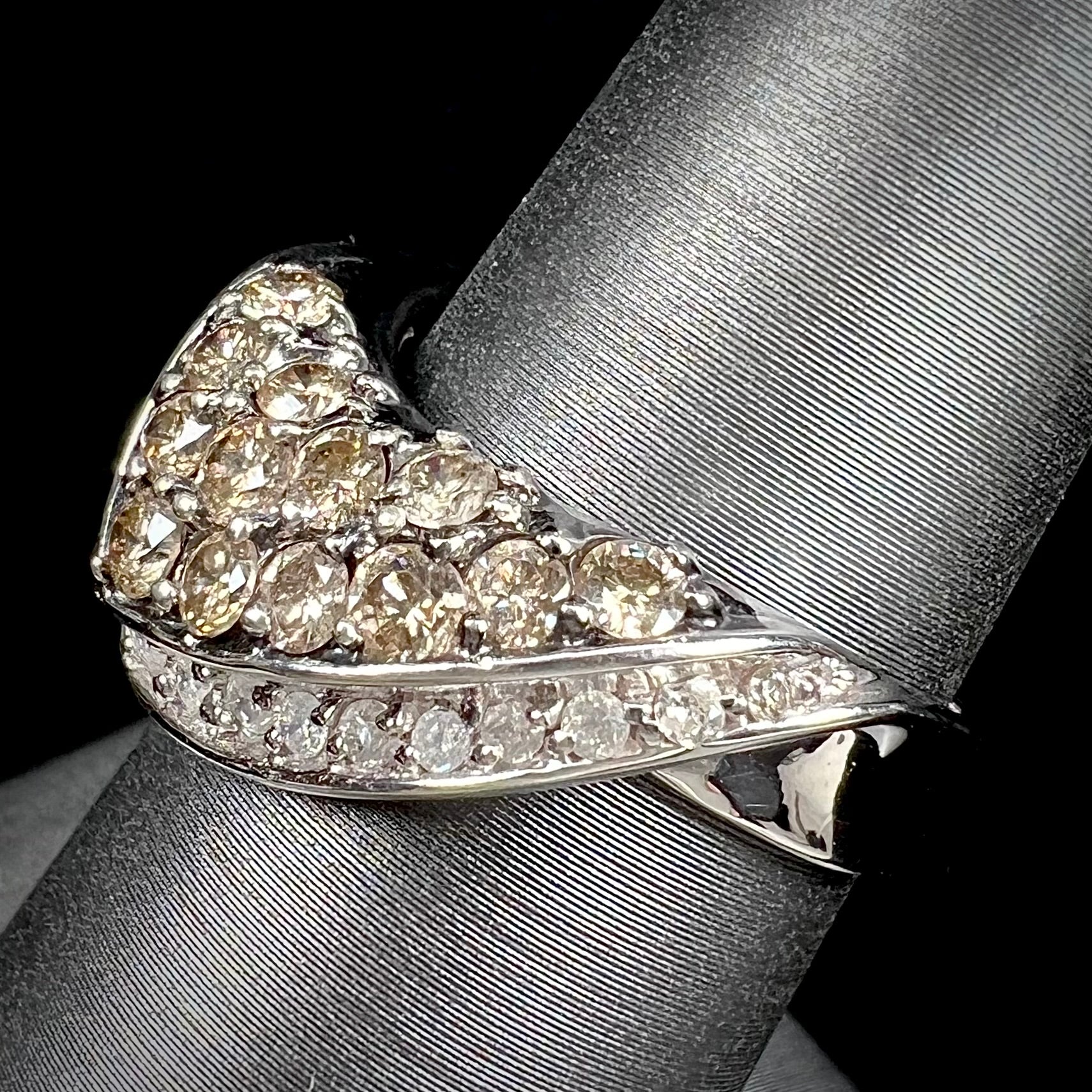 A ladies' white gold ring set with clusters of brown champagne and white diamonds.