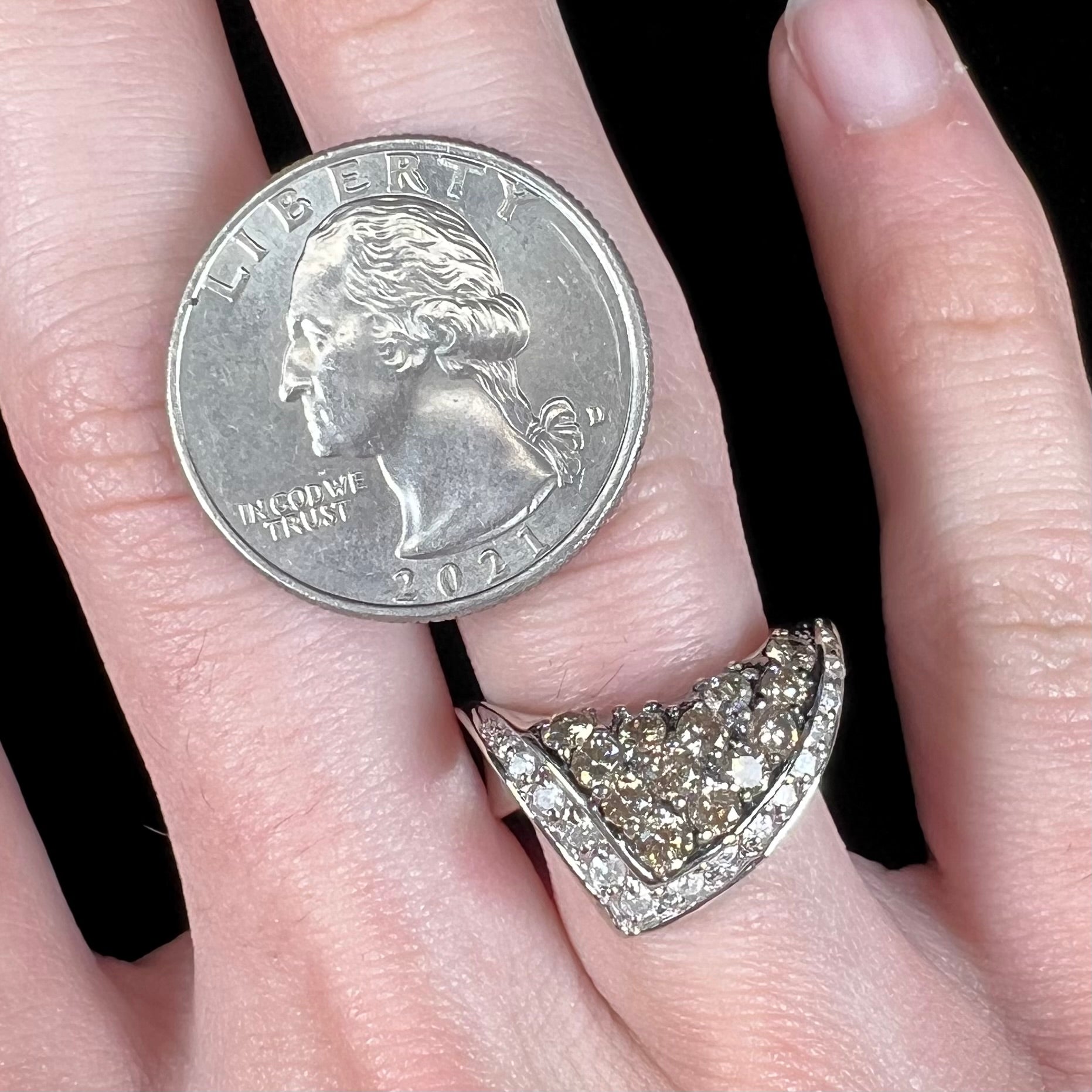 A ladies' white gold ring set with clusters of brown champagne and white diamonds.